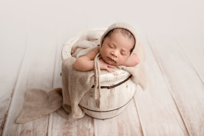 Newborn in Prop Barrel