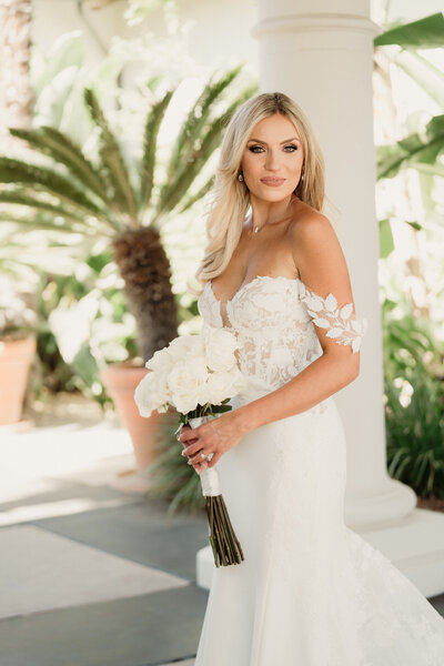 formal bridal portrait with bride holding long stem white roses  captured by los angeles wedding photographer magnolia west photography