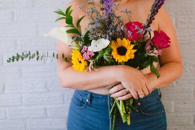 Boudoir photo of a woman holding flowers.







