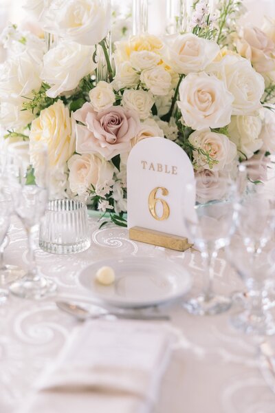 table set up at wedding with flowers and dinnerware to show top wedding planners in new york Helena Elizabeth Events