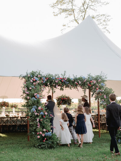 a bride and groom at their head table smiling and enjoying a speech