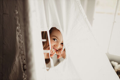little girl in tipi window  during home lifestyle photoshoot hereford