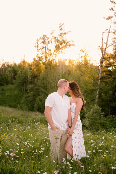 engaged couple standing in a field