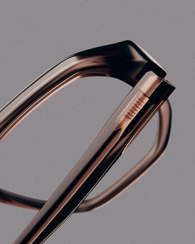 Very close-up shot of a pair of purple glasses on a gray background.