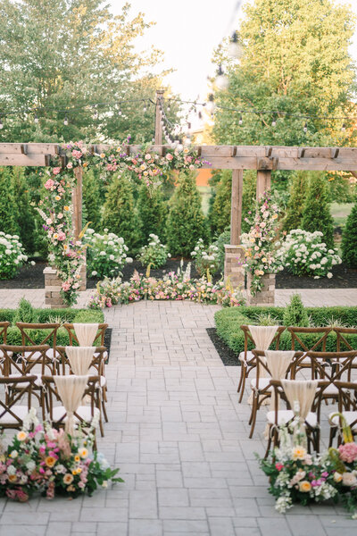 wildflower and roses covered fairytale garden pergola wedding ceremony at Willowbrook wedding venue in Pittsburgh