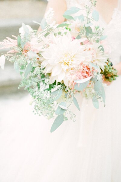 Pastel wedding bouquet of dinner-plate dahlias, eucalyptus, pink astilbe