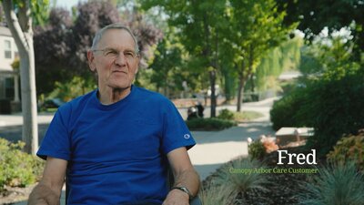 man in blue shirt sitting