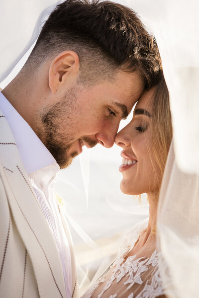 Bride and groom under the vale at sunset at their Marbella wedding venue