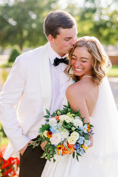 Elegant and timeless portrait of a smiling bride and groom