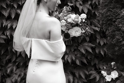 Bride brushing her lipstick off the groom's lips after giving him a kiss during their first look