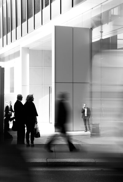 People walking into a corporate building