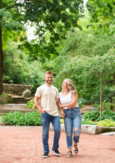 woman and man waling in park laughing