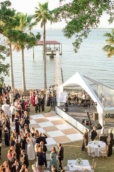 Wedding Ceremony Inspirtation Blush Draped Arbor with Climbing Greenery and Floral Lined Aisle at RiverOaks Charleston
