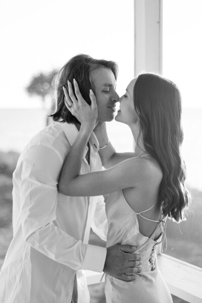 Couple share a kiss and hold each other after their engagement in Tampa, Florida