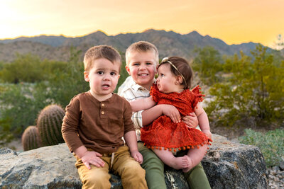 mom in Arizona holding her stomach for maternity session with photographer of Cactus & Pine Photography LLC