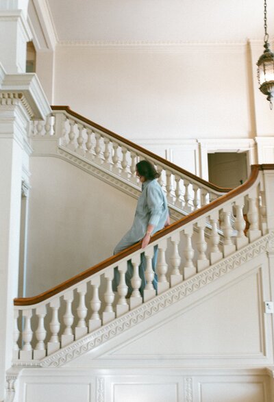 side view of New Jersey wedding photographer coming down the stairs