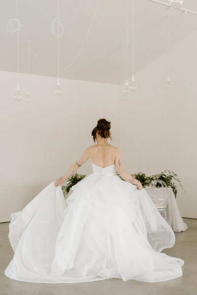 Back view of a bride in her wedding dress for her solo portrait after the wedding at Le Peaches and Cream, Gatineau