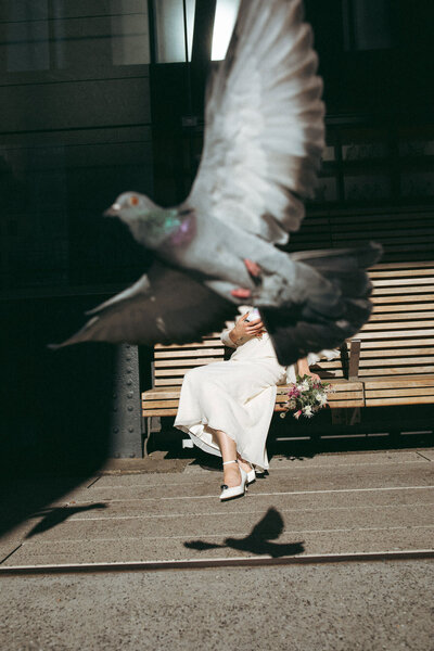 bride wearing cha cha linda vintage dress with jw anderson pigeon clutch in nyc