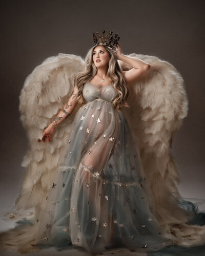 posed in a star goddess gown tasteful portrait in studio on brown