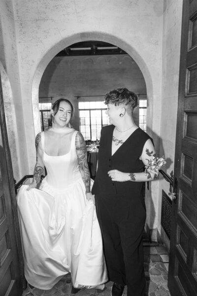 LGBTQ+ wedding couple holding hands at luxury venue in Sarasota