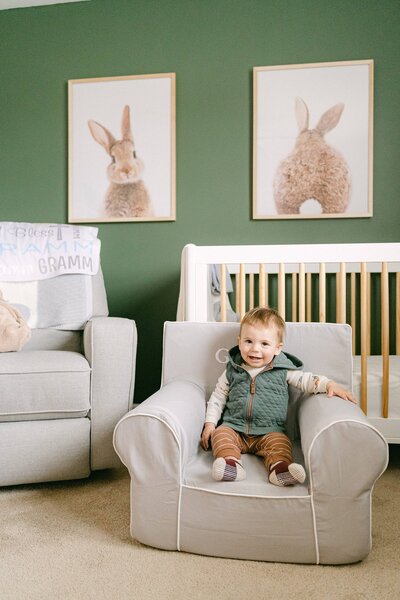 Little boy sitting in his custom chair in his room with rabbits on his wall