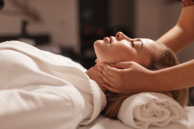 Client receiving gentle lymphatic face massage