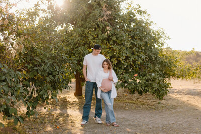 Couple taking maternity photos at Saguaro Ranch Park, Glendale AZ