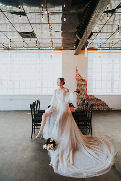 Bride sitting down wearing her elegant wedding gown