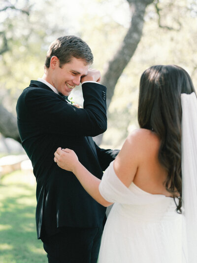 Groom crying during first look with bride
