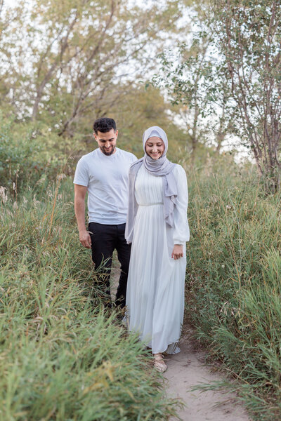 Bride leading groom while walking