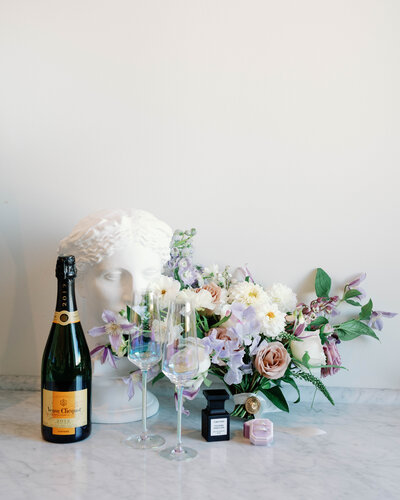 Styled photography of wedding bouquet and champagne glasses