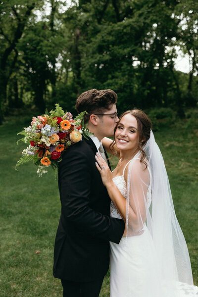 Intimate moment between bride and groom outdoors, showcasing Ryann B Photography’s personalized wedding packages in Indiana.