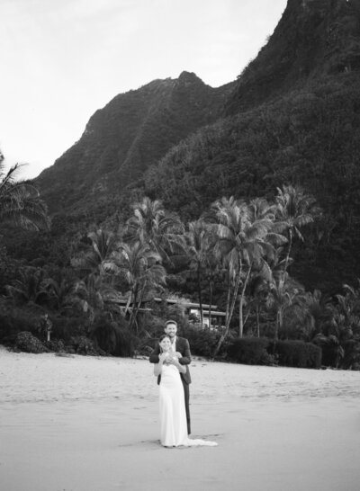 Bride standing on a sand dune