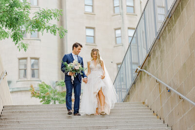 Grey Loft Studio - Bethany and Luc Barette - Wedding Photography Wedding Videography Ottawa - Ashley Graeme Side Door Restaurant Ottawa Wedding - Couple Walking down steps downtown