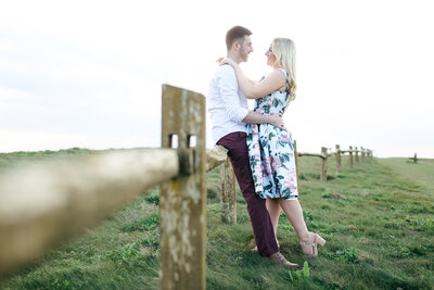 couple-hugging-in-field-at-engagement-shoot-in-kent-by-leslie-choucard-photography