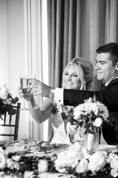 bride and groom cheers their champagne glasses during their reception at the Colony Club in Detroit