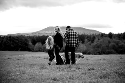 Family walking in field with dog | Family Photography Session