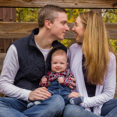A family posing with a newborn during an autumn mini session in Phoenixville, highlighting warm family moments.