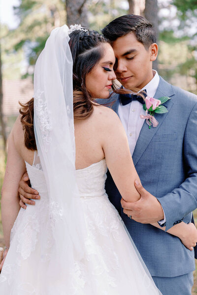 bride and groom in a posed position at an outdoor location