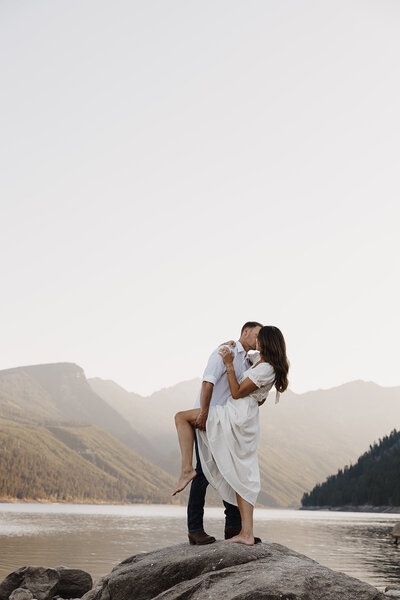 Photo of couple during engagement session in the mountains of Missoula, montana near lake como