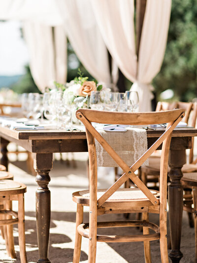 Outdoor Wedding reception table and chairs with settings, glassware, and centerpieces