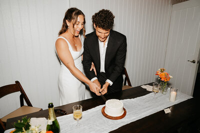 A bride and groom smiling at one another after getting married.