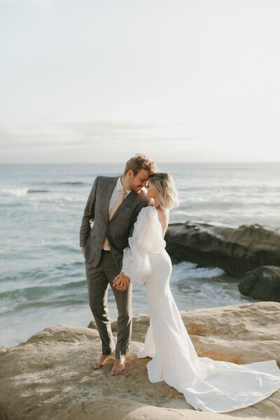 married couple standing together by the beach in la jolla