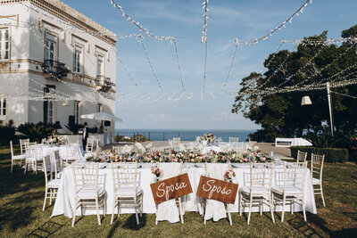 head table at a wedding under twinkle lights next to Italian villa