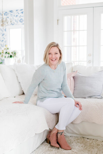 Tara smiling sitting on couch