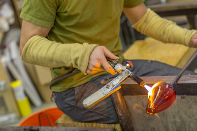 Torch heating up hand blown glass