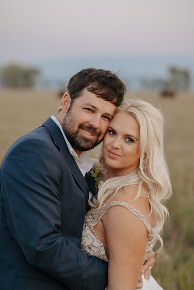 Couple smiles at camera during their elopement adventure with Foxtails Photography