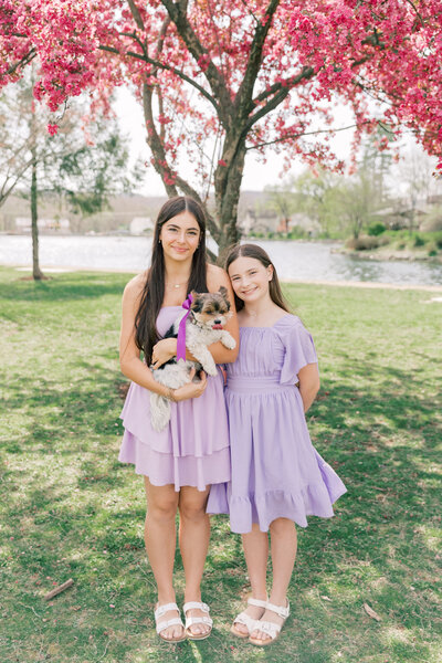 Sisters holding a puppy during family photo session in PA