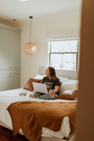 woman sitting on bed with coffee