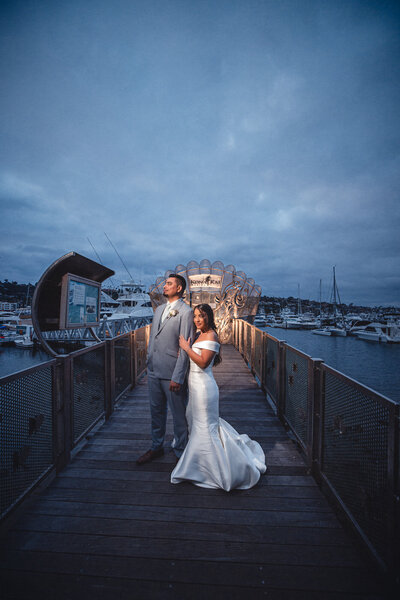 Bride and groom laughing and holding hands amid the nature at Green Gables Wedding Estate wedding venue in San Marcos.